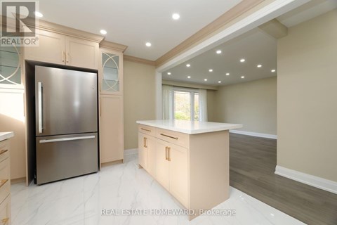 A modern kitchen with a stainless steel refrigerator and wooden cabinets.