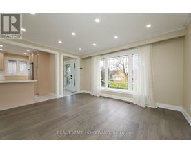 A spacious living room with a sliding glass door leading to a backyard.