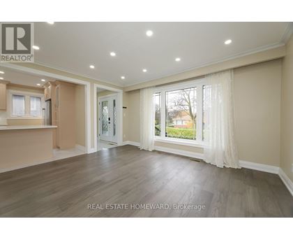 A spacious living room with a sliding glass door leading to a backyard.
