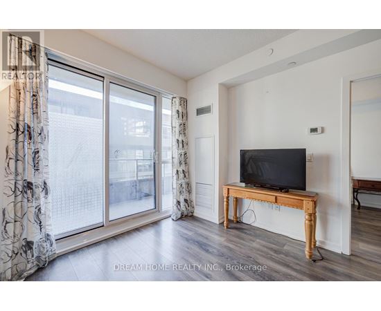 A living room with a television on a wooden stand.