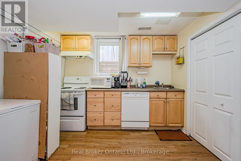 A kitchen with wooden cabinets and white appliances.