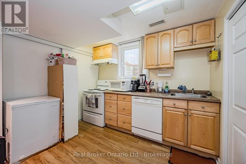 A kitchen with wooden cabinets and white appliances.