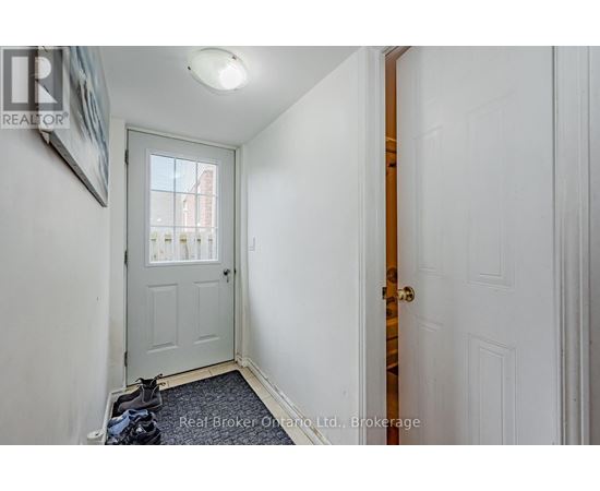 A hallway with a white door and a window.