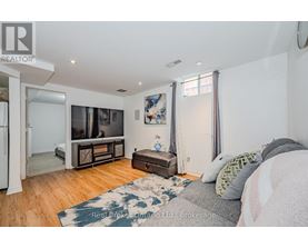 A bedroom with a bed, a dresser, and a television in the corner.