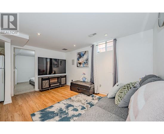 A bedroom with a bed, a dresser, and a television in the corner.