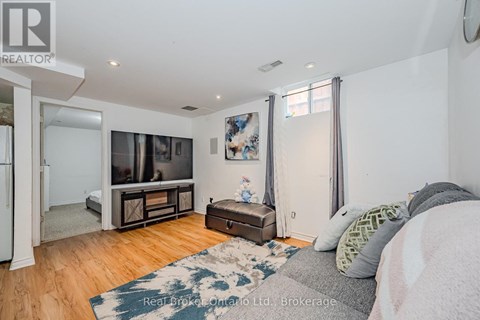 A bedroom with a bed, a dresser, and a television in the corner.