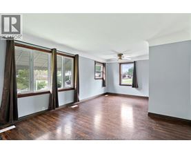 A room with wooden floors and a ceiling fan.