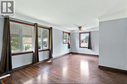 A room with wooden floors and a ceiling fan.