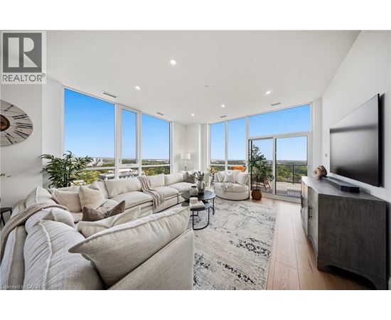A living room with a large couch and a flat screen TV.