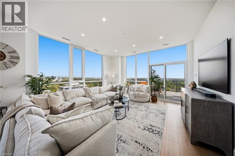 A living room with a large couch and a flat screen TV.