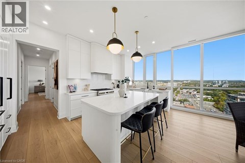 A modern kitchen with a large island and a view of the city.
