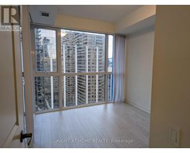A room with a view of a cityscape through a large window.