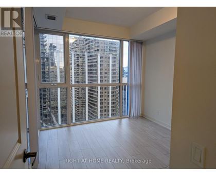 A room with a view of a cityscape through a large window.