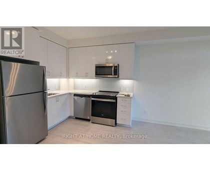 A kitchen with white cabinets and stainless steel appliances.