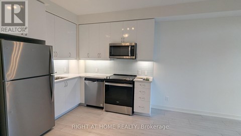 A kitchen with white cabinets and stainless steel appliances.