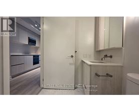 A bathroom with a sink, mirror, and toilet.