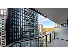 A balcony with a view of a cityscape and a building with the words "Bay Tree Real Estate" on it.