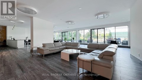 A spacious living room with a large sectional sofa and a coffee table.