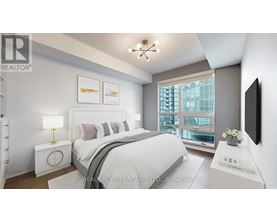 A bedroom with a large bed, a lamp, and a window overlooking a cityscape.