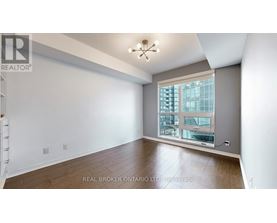 A spacious room with a large window overlooking a cityscape.