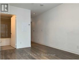 A room with a white door and a white wall.