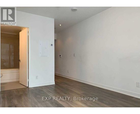 A room with a white door and a white wall.