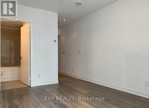 A room with a white door and a white wall.
