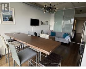 A dining room with a wooden table and chairs.