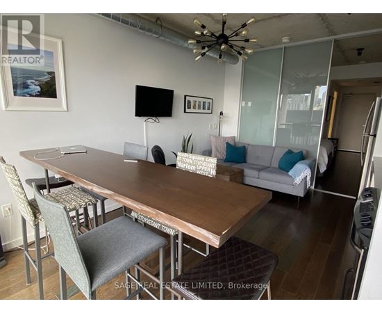 A dining room with a wooden table and chairs.