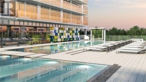 A modern building with a pool in front and a sign that says "REALTOR".