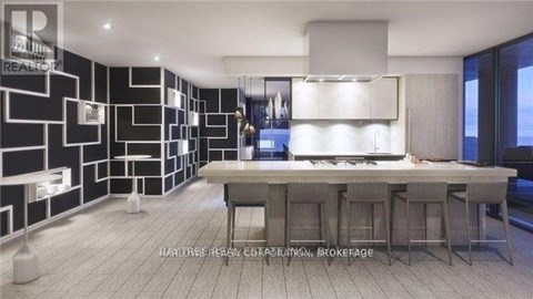 A modern kitchen with a dining table and bar stools.