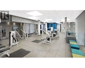 A gym with a variety of equipment including weights and cardio machines.
