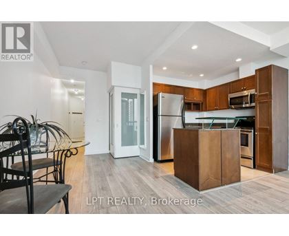 A modern kitchen with wooden cabinets and a central island.