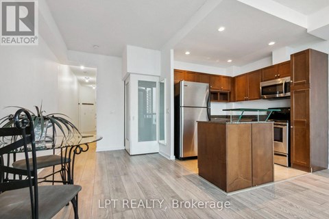 A modern kitchen with wooden cabinets and a central island.