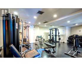 A well-equipped gym with various exercise machines and weights.