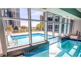 A pool inside a building with a view of the city.
