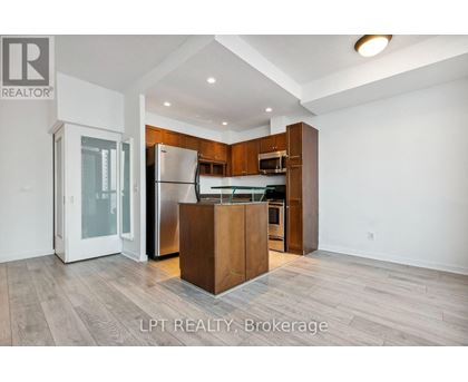 A modern kitchen with wooden cabinets and a central island.