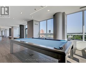 A pool table in a room with a view of the city.