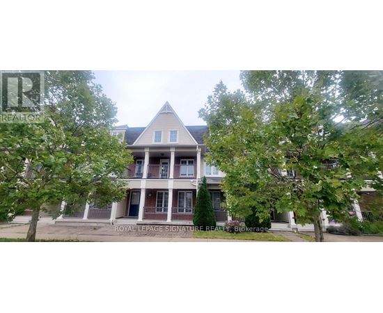 A large house with a porch and a tree in front.