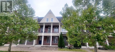 A large house with a porch and a tree in front.