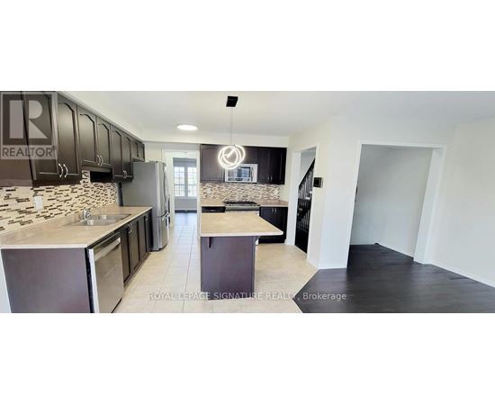 A kitchen with black cabinets and a stone backsplash.