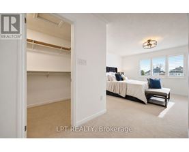 A bedroom with a bed and a window with blinds.