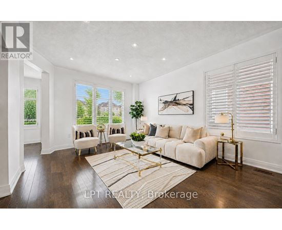 A well-lit living room with a white sofa and a coffee table.