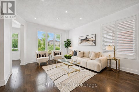 A well-lit living room with a white sofa and a coffee table.