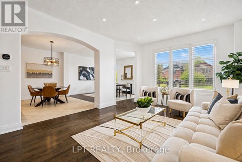 A well-lit, spacious living room with a dining area and a view of the outdoors.