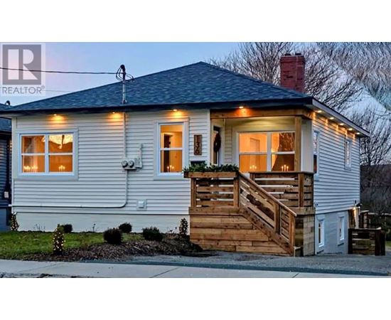 A house with a porch and lights on.