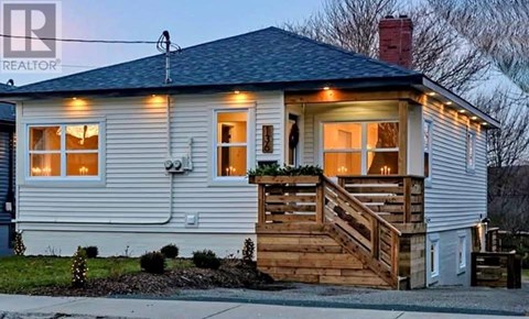 A house with a porch and lights on.