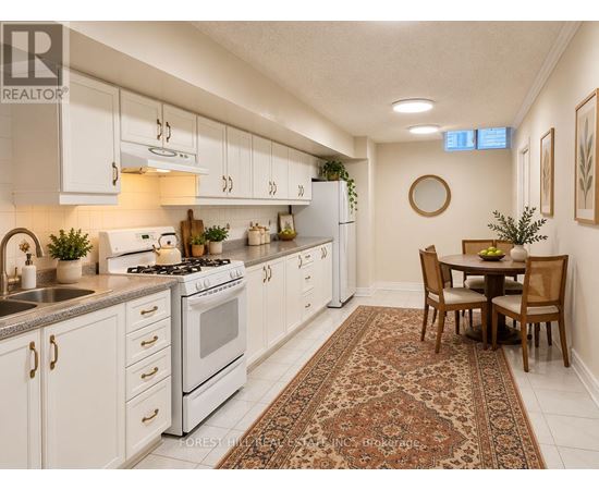 A kitchen with white cabinets and a rug on the floor.