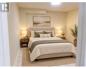 A bedroom with a bed, nightstands, and a painting on the wall.