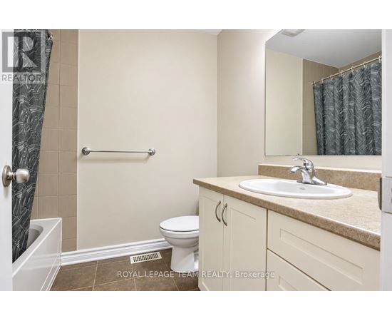A bathroom with a toilet, sink, and shower.